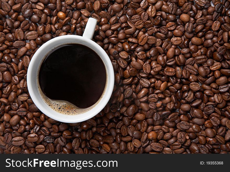 Coffee Cup On Background Of Beans