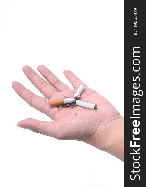 Broken cigarette in palm isolated with white background