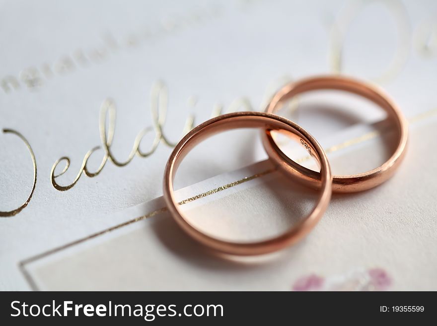 Classic golden rings on the silver wedding card