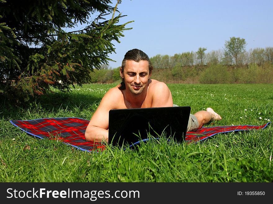 Man working with laptop outside. Man working with laptop outside