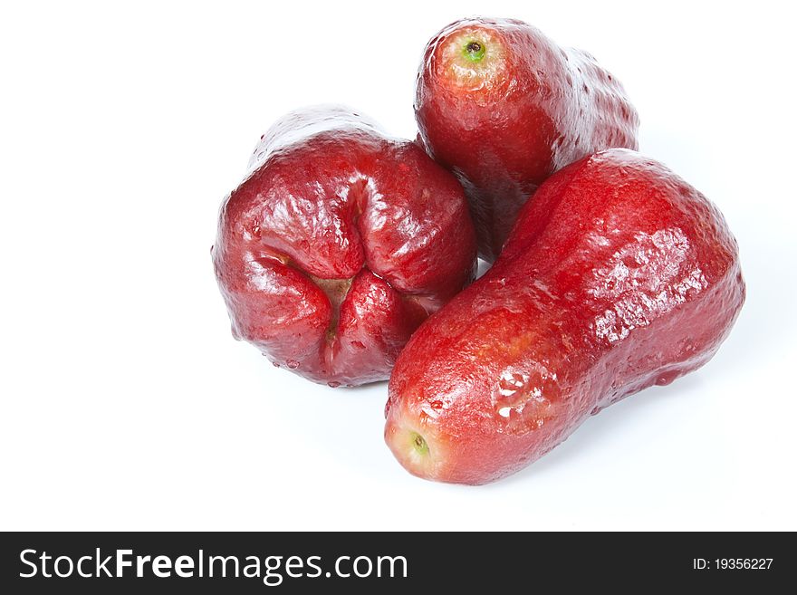 Three washed red Java apples isolated against a white background