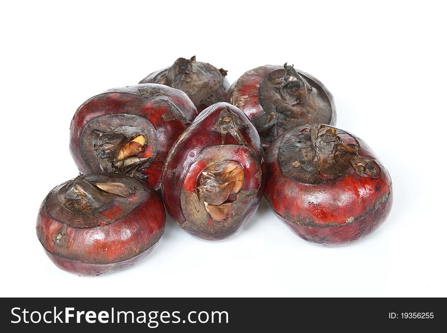 A selection of fresh water chestnuts isolated against a white background