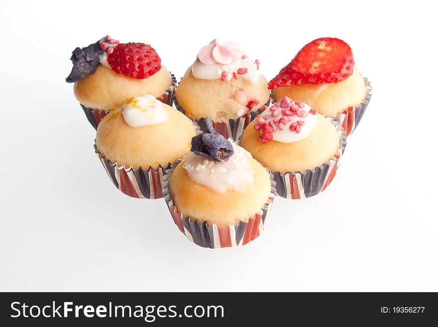 A selection of red, white & blue mini muffins in union jack paper cases. A selection of red, white & blue mini muffins in union jack paper cases