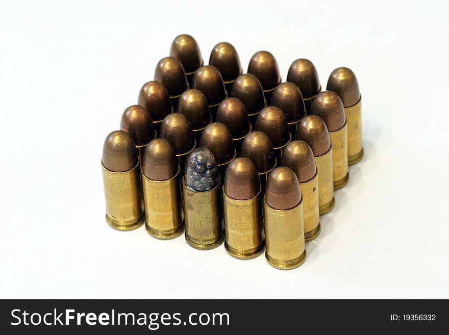 Old dusty FMJ browning bullets with one short stop bullet on white background. Old dusty FMJ browning bullets with one short stop bullet on white background.