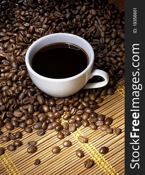 Coffee cup with roasted beans background