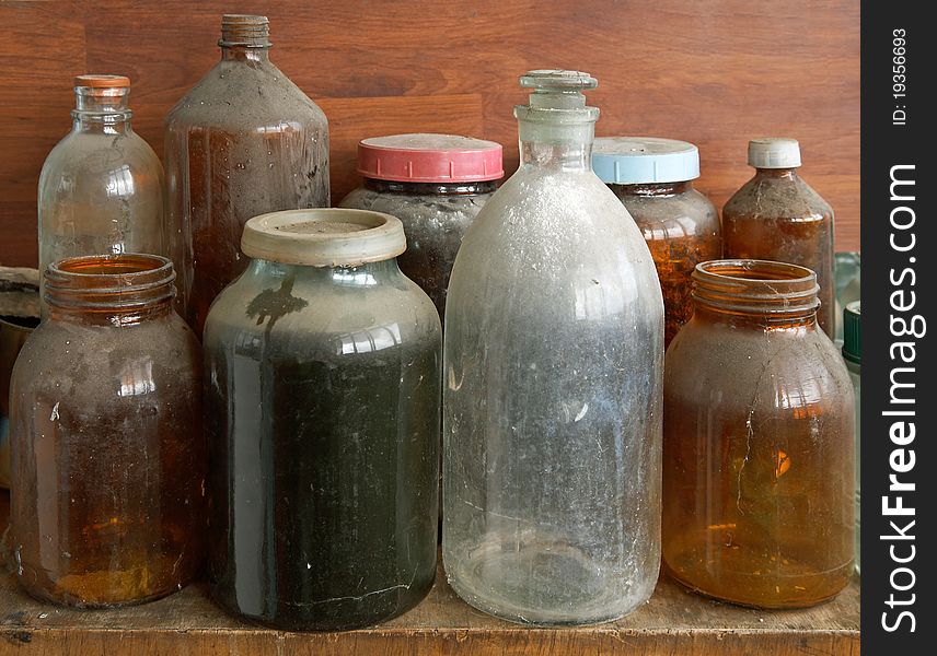 Old dusty glass bottles and jars