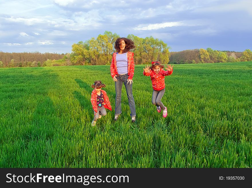 Happy mother with two kids on green field. Happy mother with two kids on green field