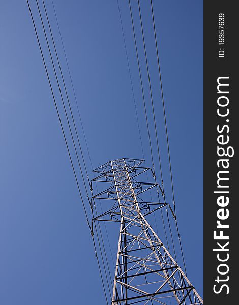 Pylon & electrical power lines set against a blue sky with no back ground distractions. Pylon & electrical power lines set against a blue sky with no back ground distractions