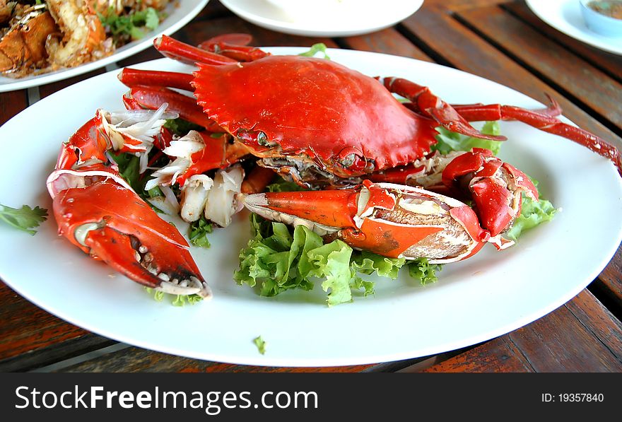 Cooked crabs on white plate