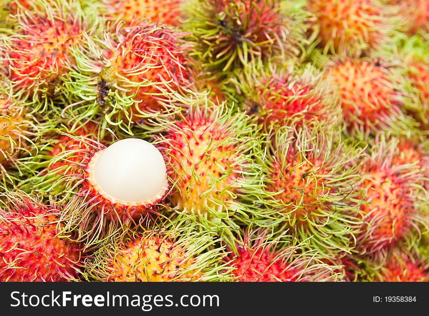 Tropical Fruit,white pulp rambutan among red rambutan. Tropical Fruit,white pulp rambutan among red rambutan.