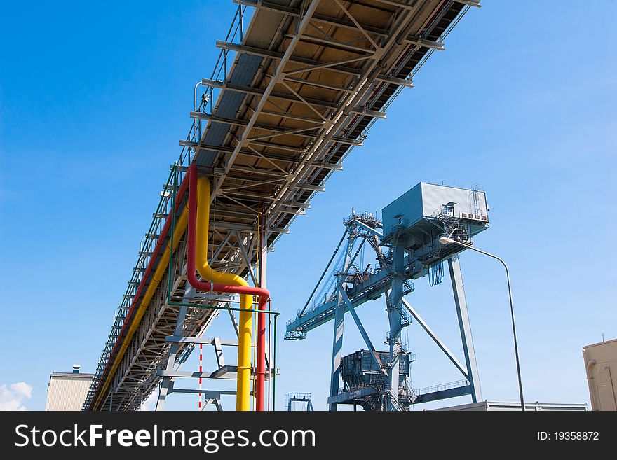 Pipelines Bridge And Giant Crane In The Jetty Pier