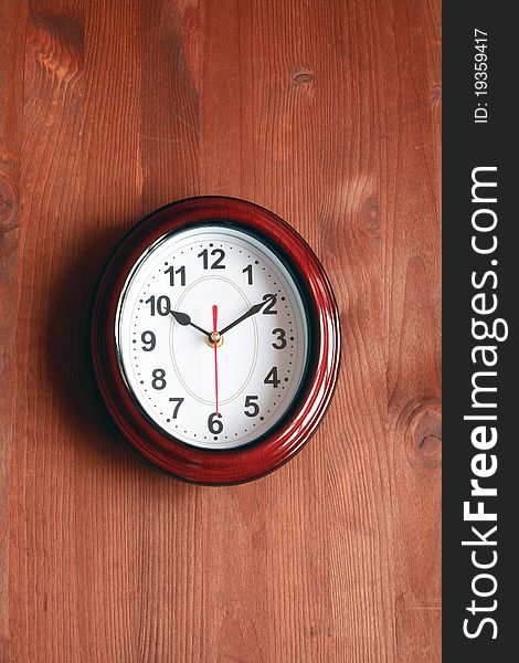 Nice modern clock hanging on wooden surface. Nice modern clock hanging on wooden surface