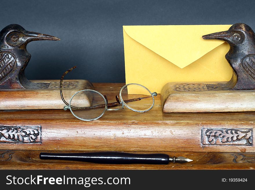 Nice old vintage wooden desk set and envelope on dark background. Nice old vintage wooden desk set and envelope on dark background