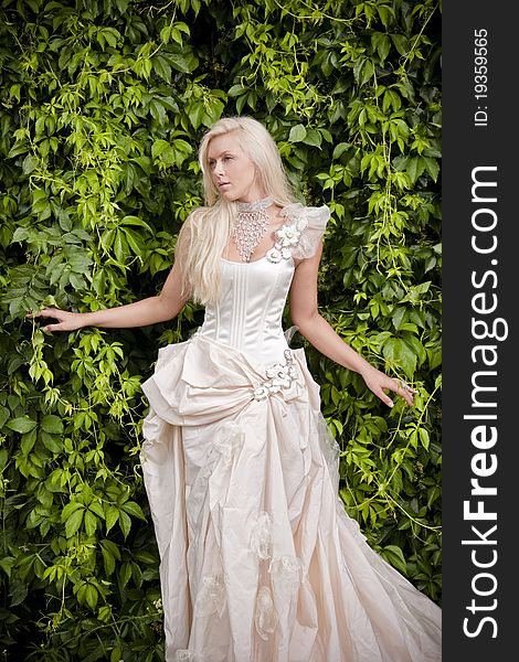 Beautiful blond bride in luxury clothes