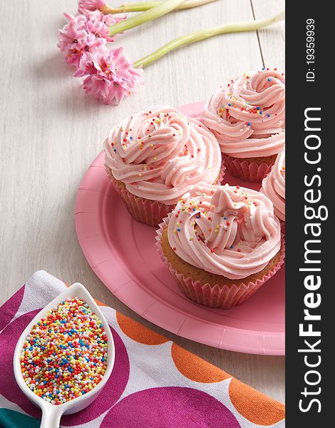 Delicious sweet cupcakes with ping topping. Delicious sweet cupcakes with ping topping