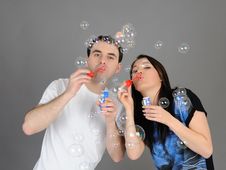 Pretty Couple In Love Blowing Bubbles Stock Images