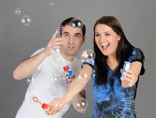 Pretty Couple In Love Blowing Bubbles Royalty Free Stock Photos