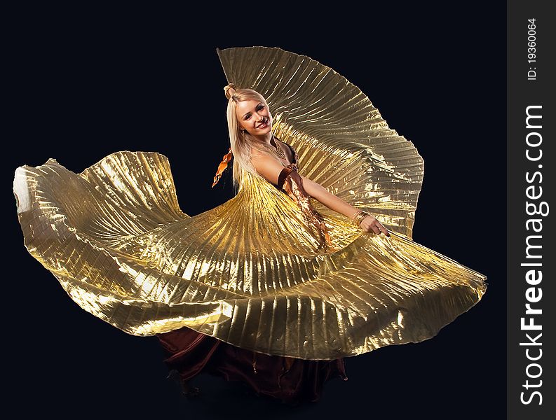 Beauty blond girl dance with flying gold wing - oriental costume. Beauty blond girl dance with flying gold wing - oriental costume
