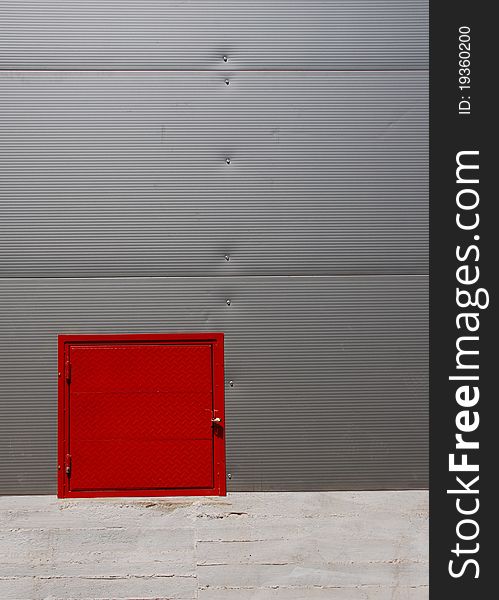 Corrugated facade with red details. Corrugated facade with red details