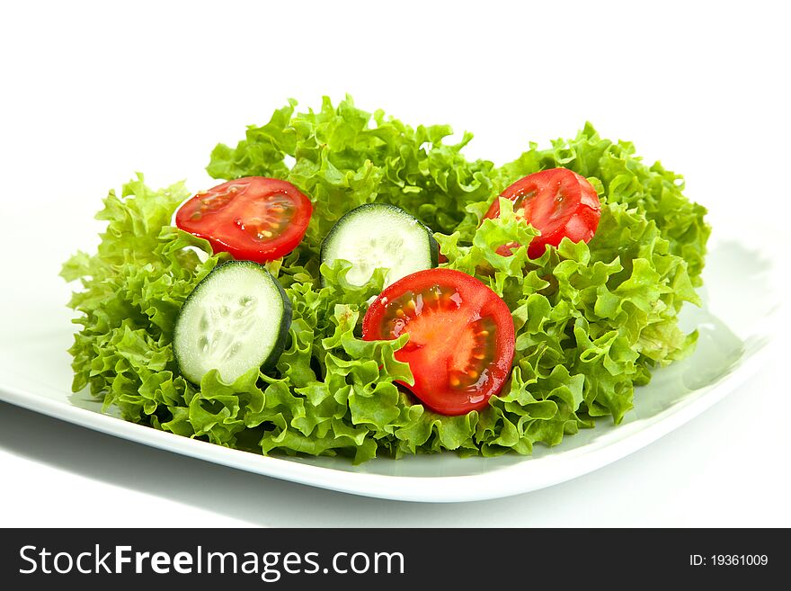 A small portion of salad on a white plate. A small portion of salad on a white plate.