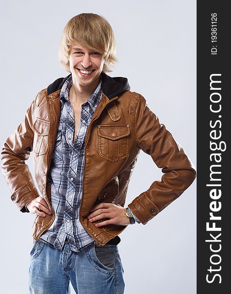 Handsome young man in leather jacket, studio portrait