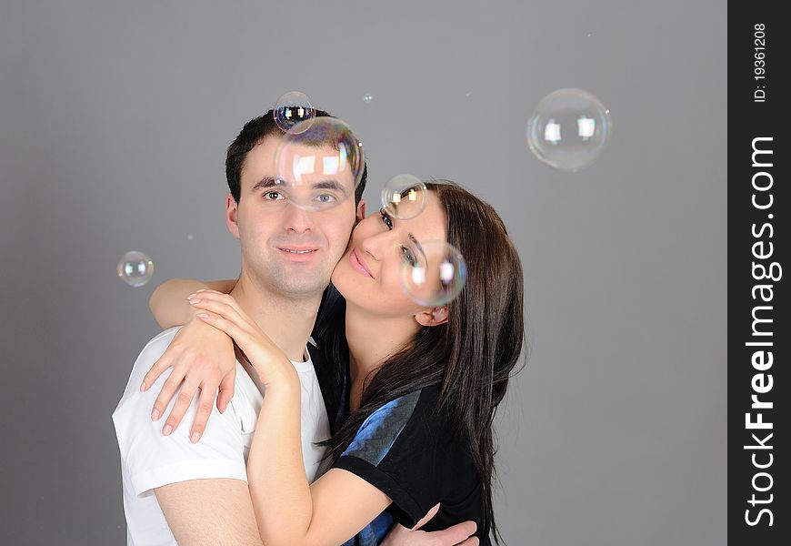 Pretty couple in love blowing bubbles and having fun