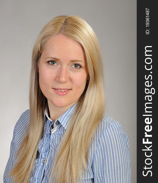 Portrait of young pretty smiling woman in a shirt