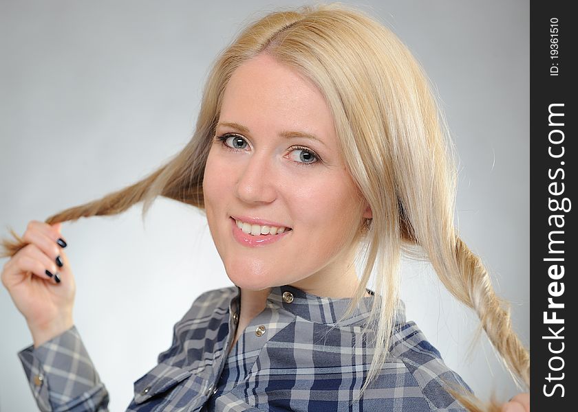 Portrait of young pretty smiling woman in a shirt