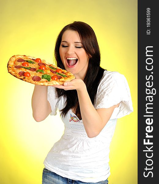 Pretty young casual girl with tasty pizza in delivery paper box. isolated on white background