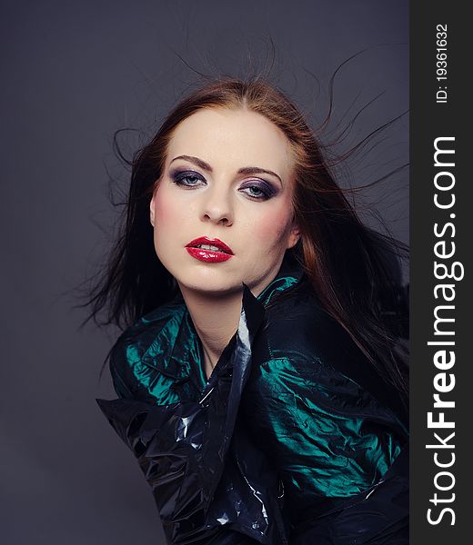 Beautiful fashion model with elegant make-up. gray background