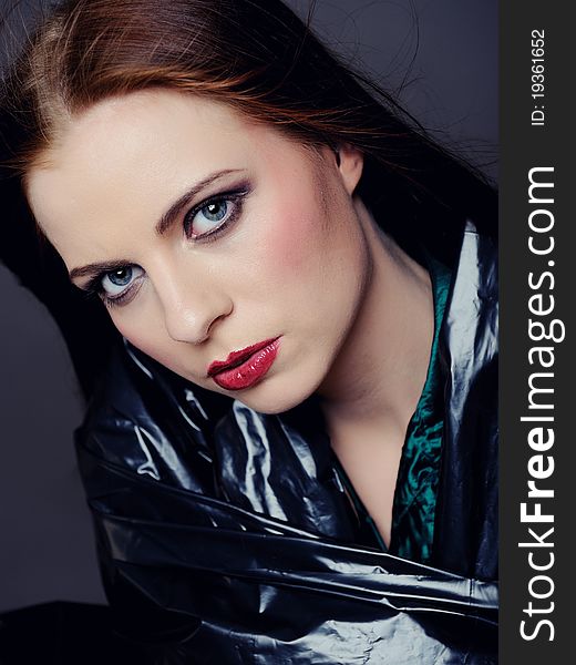 Beautiful fashion model with elegant make-up. gray background