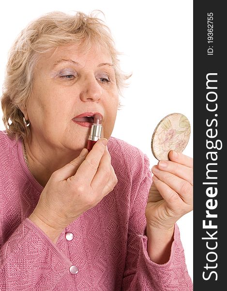 The elderly woman does a make-up on white