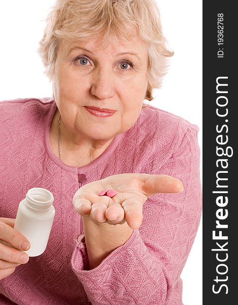The elderly woman with tablets on white background