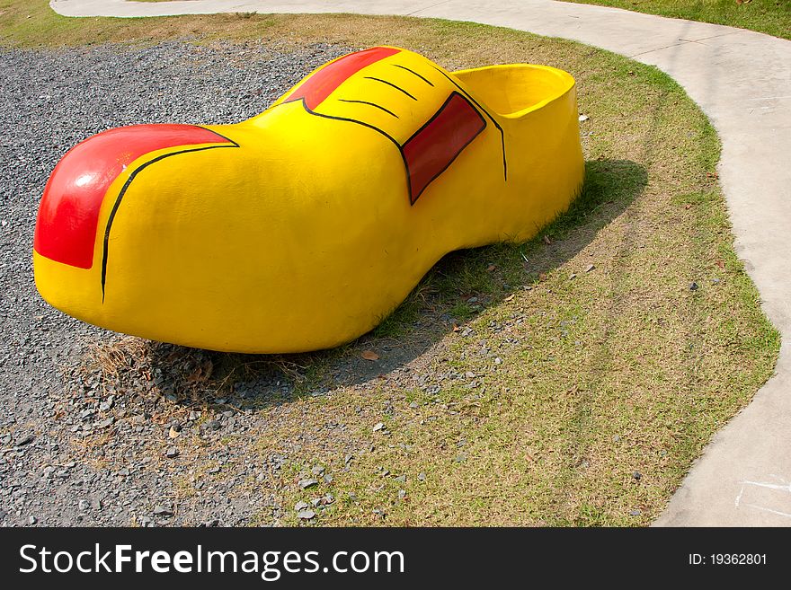 Funny yellow shoe in a park. Funny yellow shoe in a park