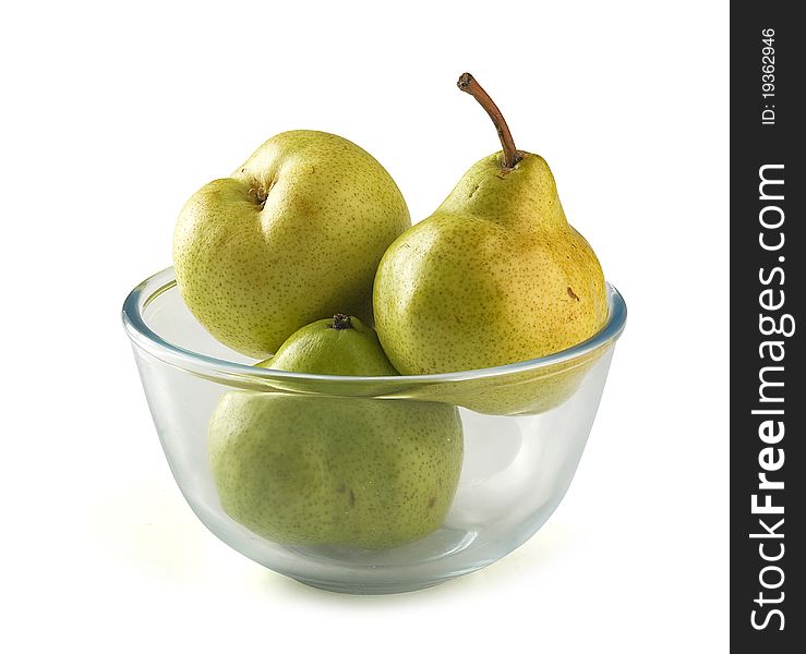 Three yellow pears in the glass bowl