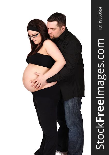 Happy expecting couple standing with hands on her bare belly. isolated on white. Happy expecting couple standing with hands on her bare belly. isolated on white