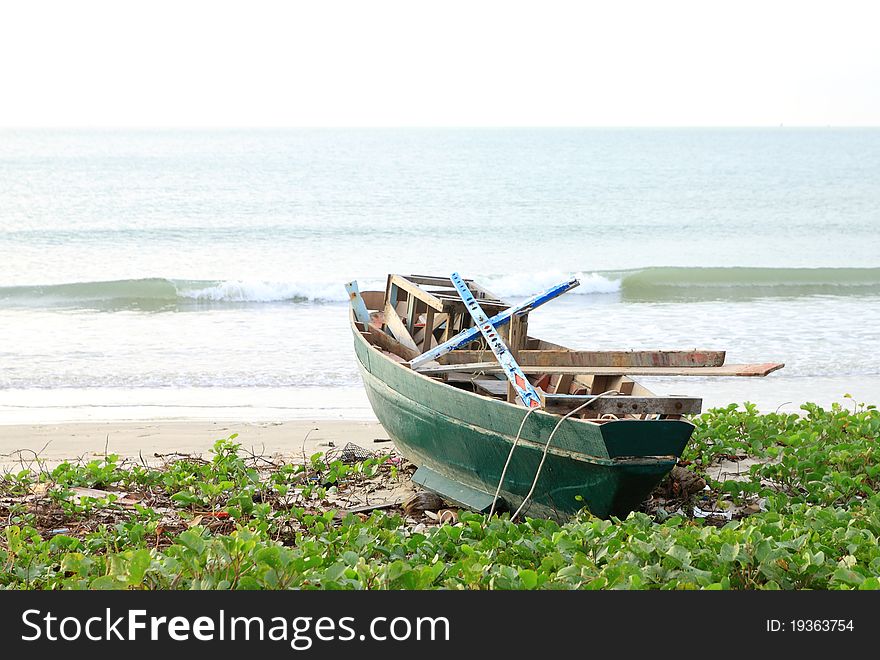 A green boat on a beach,Thailand