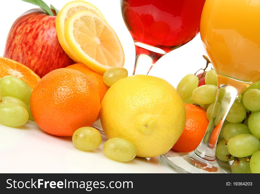 Fresh fruit and juice on a white background