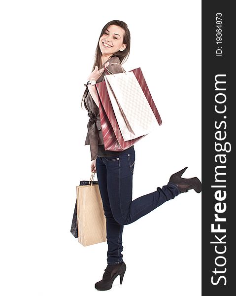 Woman holding shopping bags against a white background