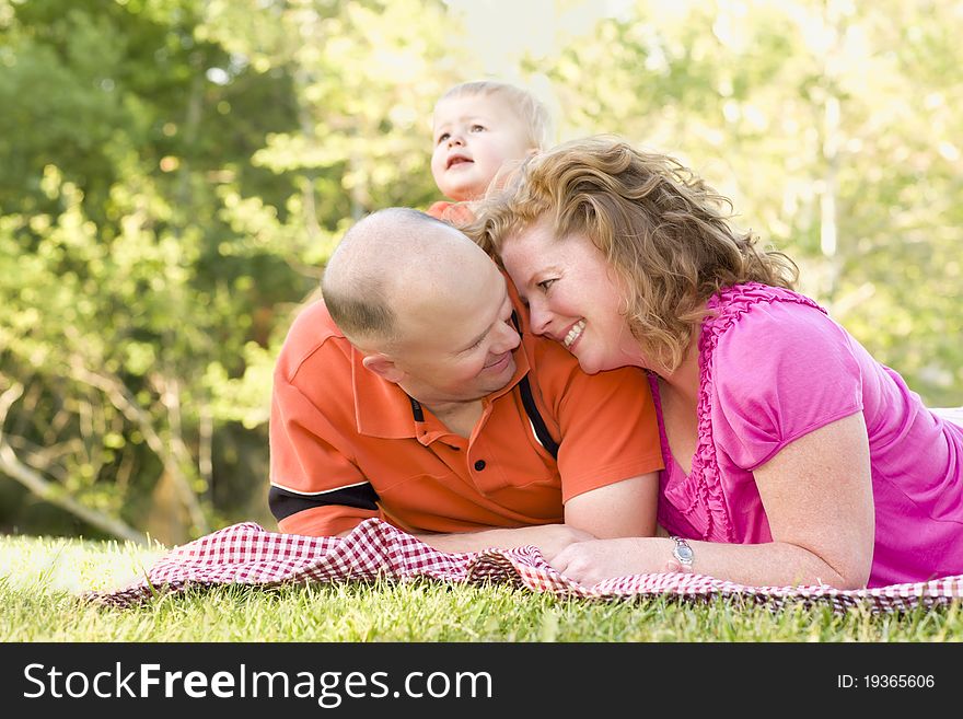 Affectionate Couple with Son in Park