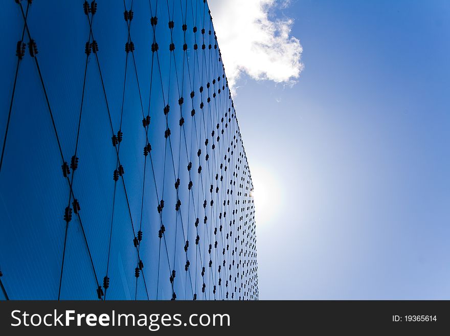 Modern building reflecting the a deep blue sky and clouds. Modern building reflecting the a deep blue sky and clouds