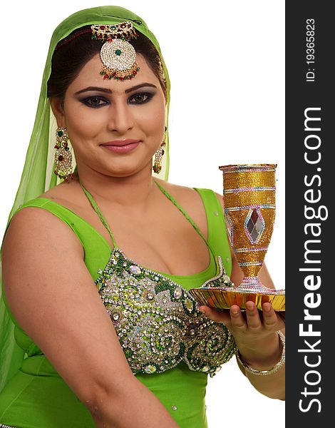 Young Indian girl in traditional clothing on wedding day with beautiful milk glass