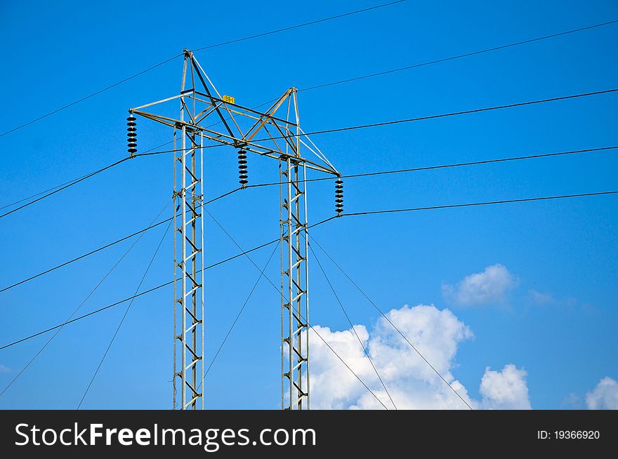 High voltage electricity pylon with blue sky in Thailand.