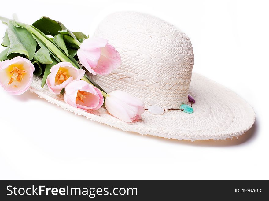 White straw summer hat with flowers tulips
