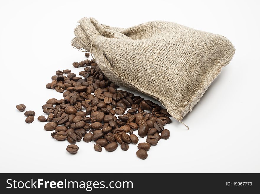 Coffee beans spilled on a white background