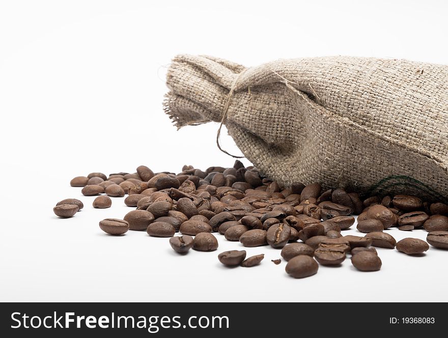 Coffee beans spilled on a white background