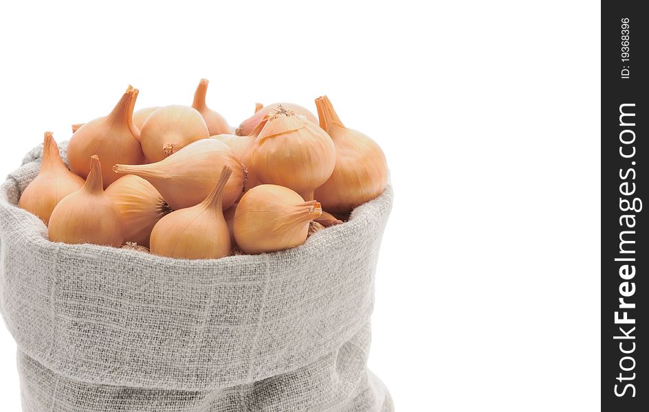 Small onion in linen bag. Storing onions in the winter.