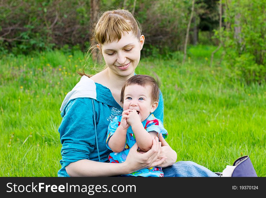 Young mother with little son relaxing at the park. Young mother with little son relaxing at the park