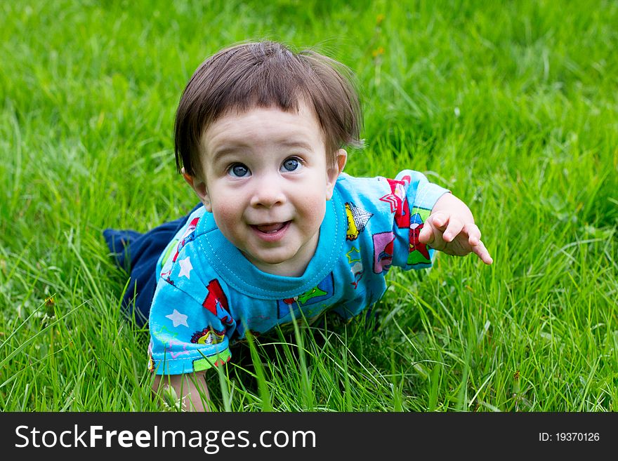 Single little boy creeping at the park. Single little boy creeping at the park