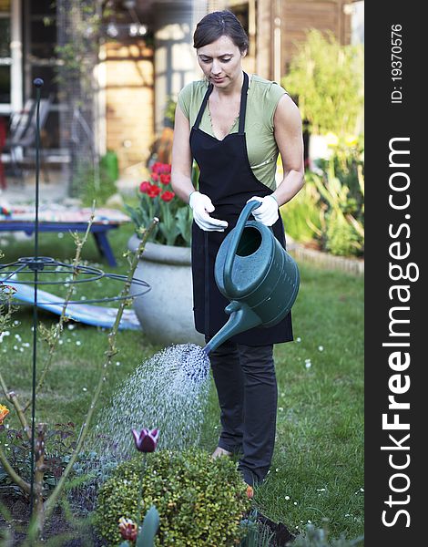 Woman working in garden and smiling. Woman working in garden and smiling